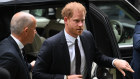 Prince Harry arrives at the High Court in London to give evidence in his lawsuit against the tabloids.