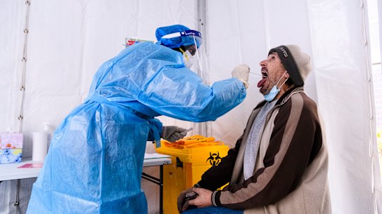 A man comes forward for testing in Auburn, NSW.