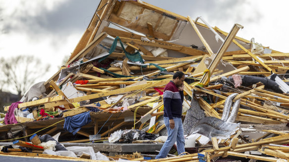Gopala Penmetsa walks past his house after it was leveled by a tornado near Omaha, Neb., USA.