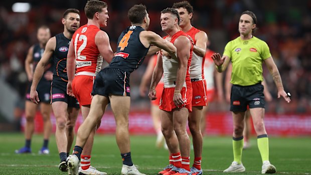 Toby Greene and Tom Papley get in each other’s faces.