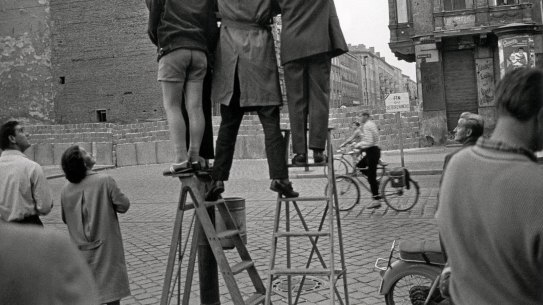 West Berliners look across the Berlin Wall to the east in 1961. 