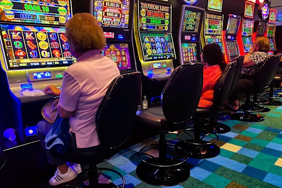 Patrons gamble on the poker machines at Bankstown Sports Club in Sydney