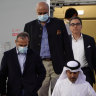 From left, Emad Sharghi, Morad Tahbaz and Siamak Namazi, former prisoners in Iran, walk out of a Qatar Airways flight in Qatar.