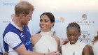 Prince Harry with Meghan Markle and Sentebale chair Sophie Chandauka at the charity polo match.