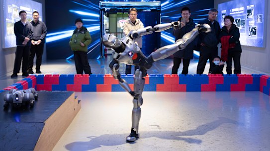 A humanoid robot performs a kung fu kick at the Robot Mall in Beijing.