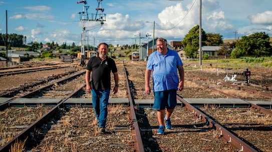 Craig Moore (right), spokesman for Cooma Monaro Railway walking with Gordon Strachan, President of the Cooma Monaro Railway. Captured at Cooma Railway Station. November 11th, 2022. Photo by Katie Phillips / Sydney Morning Herald.