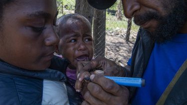 One-year-old Wanita receives a Polio vaccination.
