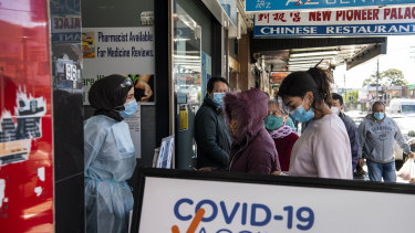 People in western Sydney queue for COVID-19 vaccinations.
