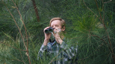Michael Livingston searches for birds in Royal Park during lockdown. 
