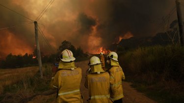 The RFS watches the Gospers Mountain fire in December last year.