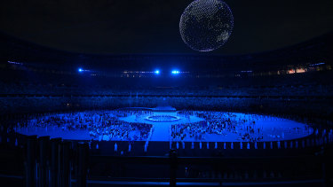 A drone display is seen over the top of the stadium. 