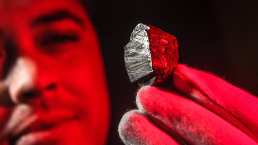 Dr Stuart Mills with the Wedderburn meteorite. Scientists have discovered a new mineral buried inside it, forged in the core of a planet that no longer exists.