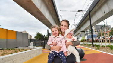 Dianne Liddell and her daughters Lillie Liddell, 2, and Florence Liddell, 4 months, under 'sky rail' in Carnegie.