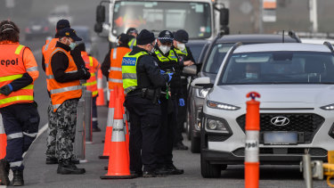 Victorian Police and the ADF Australian defence force man a road block at Coldstream.