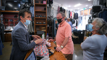 Harry Hutchinson with customers Alan and Lorraine Bamford at his Berwick clothing shop on Wednesday.