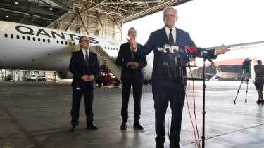 Prime Minister Scott Morrison with Qantas chief executive Alan Joyce (left) and NSW Premier Dominic Perrottet on Friday. 