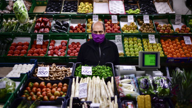 Is four days enough? A man minds his fresh food market stall in Pamplona, northern Spain. 