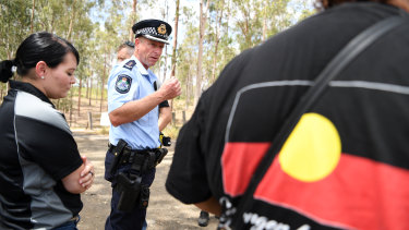 Queensland Police Acting Inspector Brett Wendt talks to protesters in Deebing Heights on Thursday.