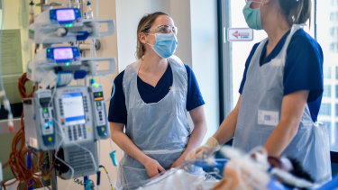 Annette Dlugogorski and a colleague care for a patient in Royal Melbourne Hospital's intensive care unit. 