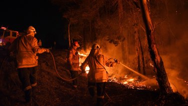 NSW Rural Fire Service volunteers working through the night in January to prevent a flare up from crossing the Kings Highway between Nelligen and Batemans Bay.  