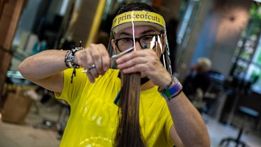 Hair stylist Cristiano Basciu takes the necessary precautions to get back to work after the salon was closed for over three months due to the pandemic.