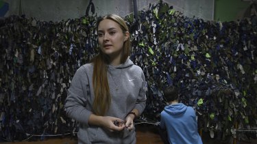 High school student Tetiana Onopriienko, 16, is now volunteering to make camouflage nets - used by  Ukrainian military, police and civil defence - in a community shelter in Uman. 