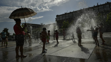 People cool off in a fountain in Pamplona, Spain.
