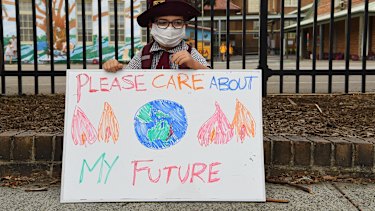 Scarlett Rigato, 5, holds a sign during a climate change protest by parents and students in Sydney last year.