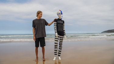 Tom Denby with his wetsuit to protect divers from shark bites.