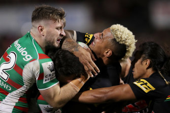 Penrith’s Viliame Kikau is wrapped up by the Rabbitohs defence.