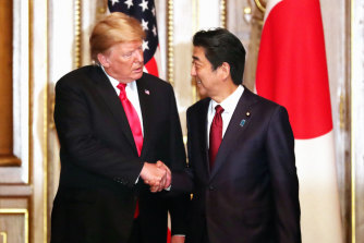 Then-president Donald Trump shakes hands with Shinzo Abe in Japan in 2019. 