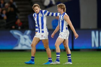 Hugh Grenwood (left) encourages North Melbourne teammate Jason Horne-Francis.