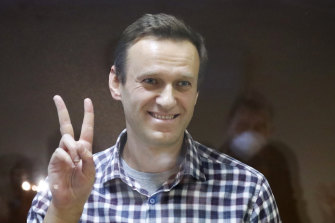 Russian opposition leader Alexei Navalny gestures as he stands in a cage in the Babuskinsky District Court in Moscow, Russia, in February.