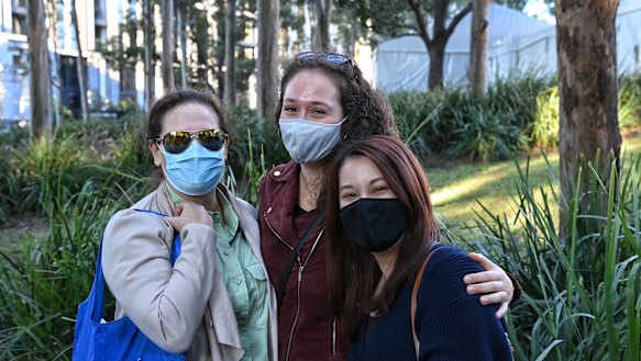 Gail Rodney, Dayna Kohn and Tomoko Masters arrive for the opening of the Olympic Park vaccination hub on Monday at 8am.