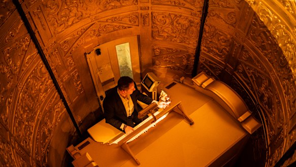 Organist John Giacchi playing the Wurlitzer organ as it ascends in its console from the stage. 