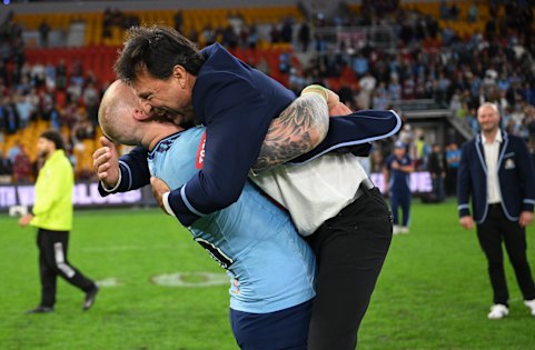 Laurie Daley celebrates her NSW Origin series win with a bear hug from front-rower Mitch Barnett.