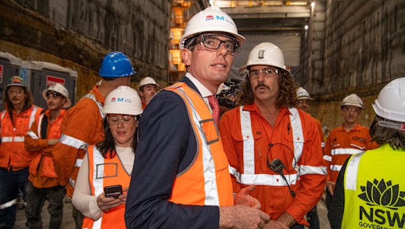 NSW Treasurer Dominic Perrottet with Sydney Metro workers on Thursday.