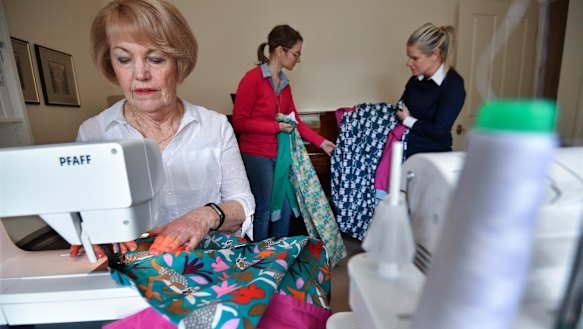 Sewer Carol McCooke has been helping Bendigo GPs Dr Nicole Townsend (left) and Dr Kirby White (right) produce thousands of reusable protective gowns.