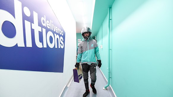 A delivery rider takes an order from Deliveroo's dark kitchen in Windsor. 
