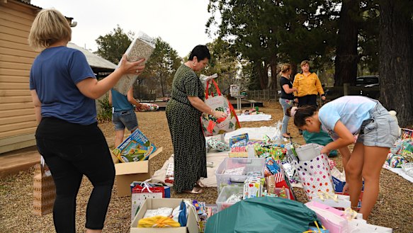Community members sort out donated Christmas presents into categories in Balmoral, which was severely impacted by fires.