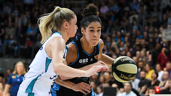 Canberra Capitals' Kia Nurse fights for the ball with Aimie Clydesdale of the Southside Flyers.