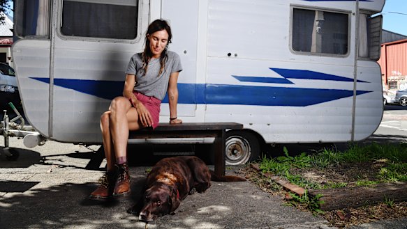 Holly Throsby, wearing what she describes as her "galah" colour palette, and her dog Jones in Marrickville.