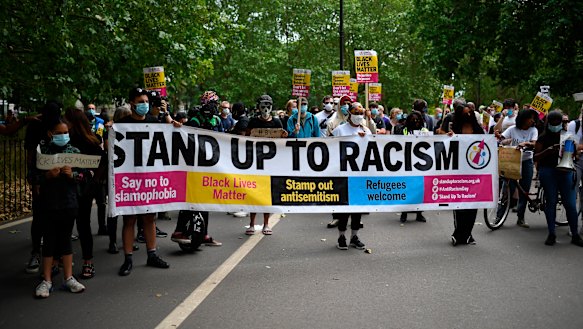 Protesters supporting the Black Lives Matter movement hold placard and banners as they gather at Hyde Park last Saturday. 