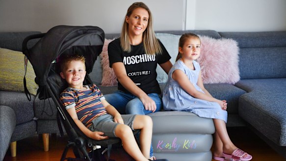 Louisa Williams with her children Mila and Jack and some of the baby equipment she shares through sharing platform Kindershare.