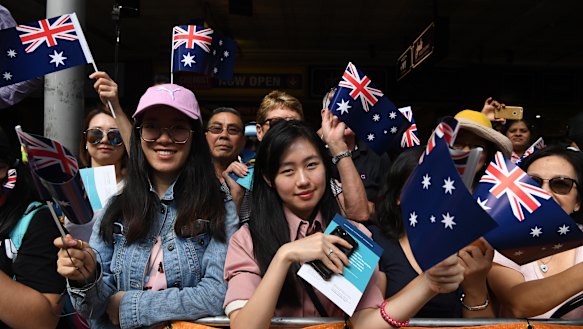Members of the public line the route of Melbourne's Australia Day parade.