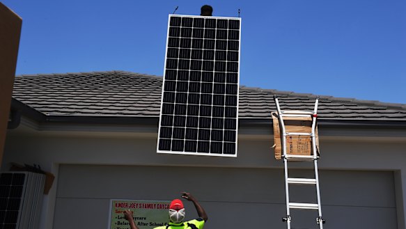 Going up: The Narang family get their solar panels installed by More Green Energy on their home in The Ponds, in Sydney's west, this week.
