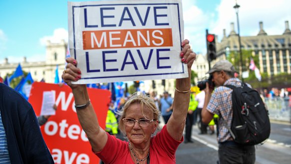 Pro-Brexit demonstrators gather and march at Parliament Square in London on Tuesday.