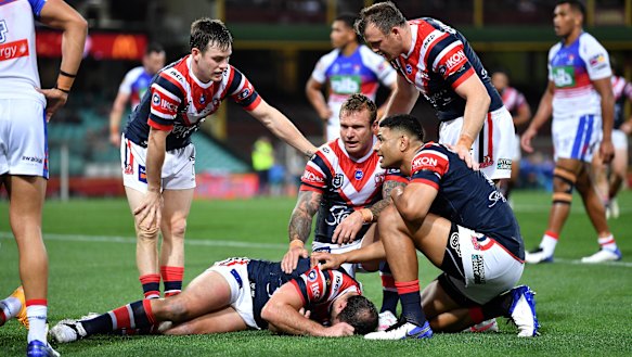 Roosters players show their concern for Boyd Cordner after the skipper went down against the Knights.