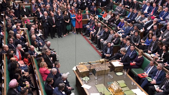 Britain's Prime Minister Theresa May at center right front row, speaks to lawmakers in the House of Commons. 