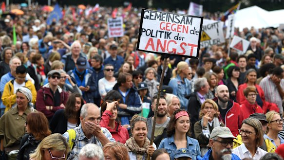 A woman with a poster reading 'United Against The Politics Of Fear' at a demonstration in Munich in July.